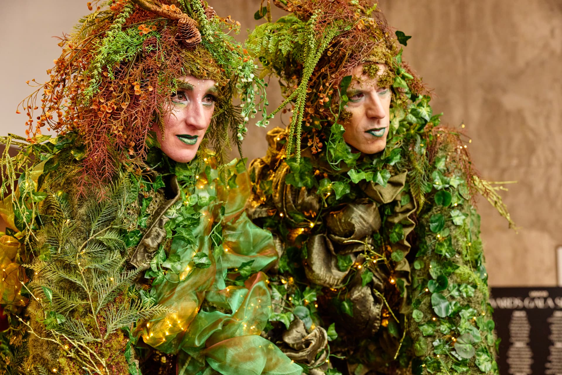 Performers wearing elaborate living greenery costumes